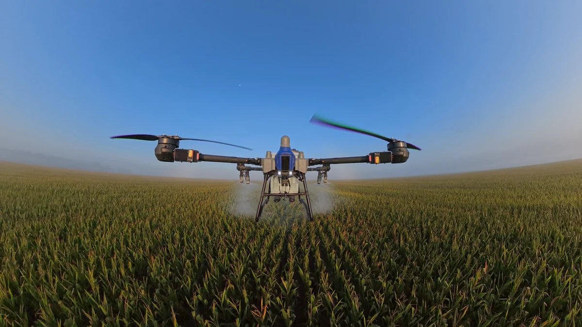 EAVision J150 agricultural spray drone over crop rows